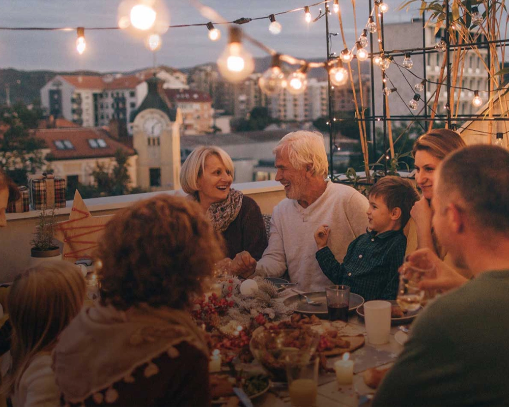 a family gathered at a table outside for a party