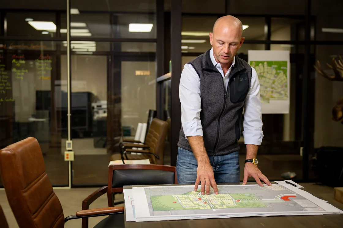 Jason Roberts looking down at a building plan
