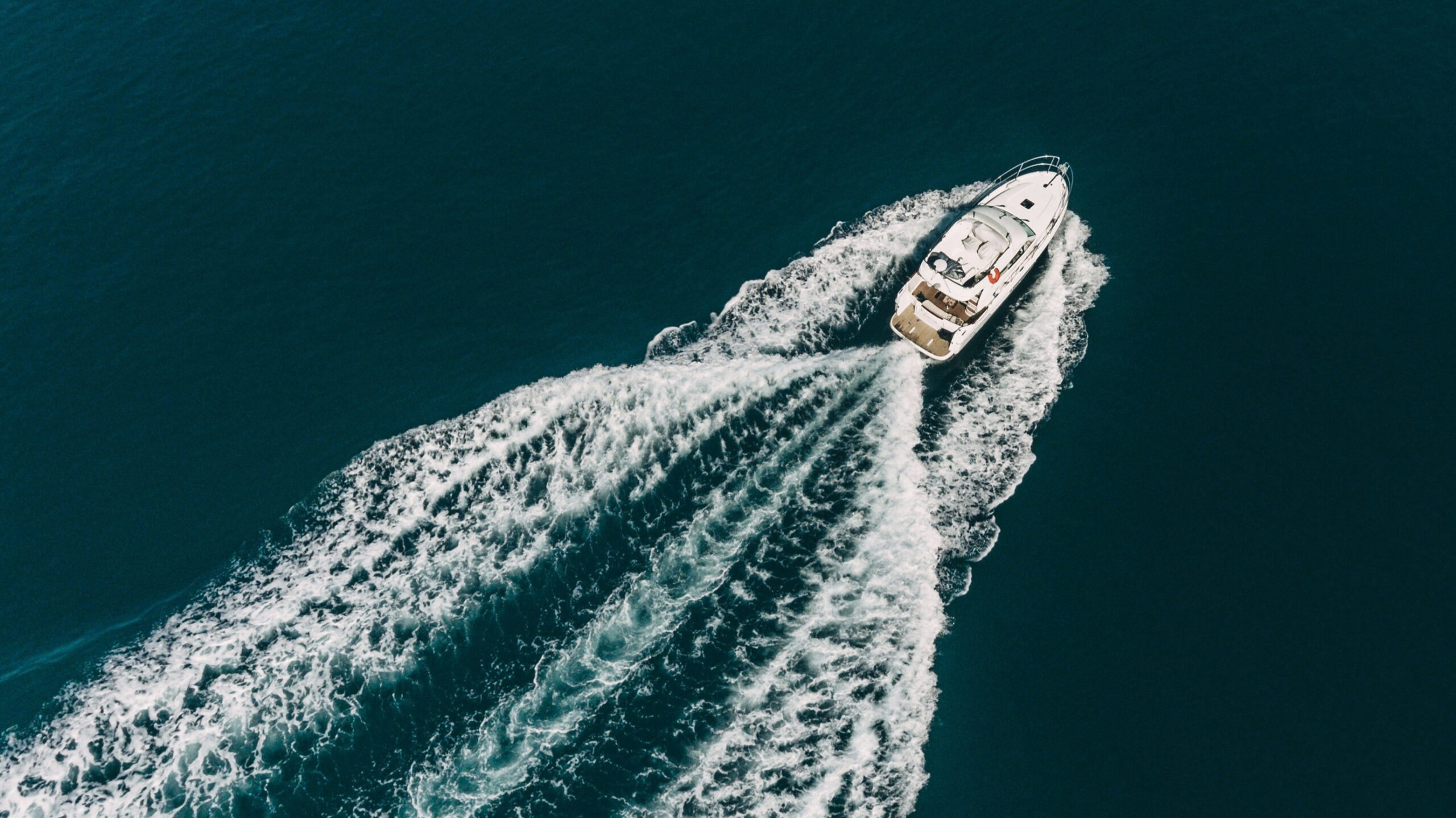 aerial photo of boat leaving wake in water